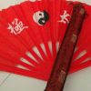 Red tai chi fan and case. Fan features taiji yin and yang symbol